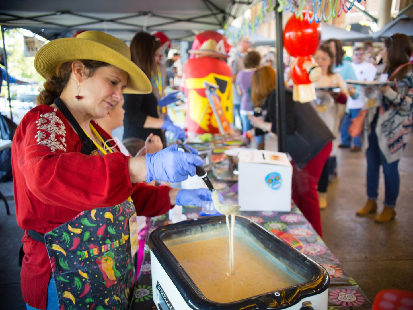 A cheese dip-maker shows off her skills