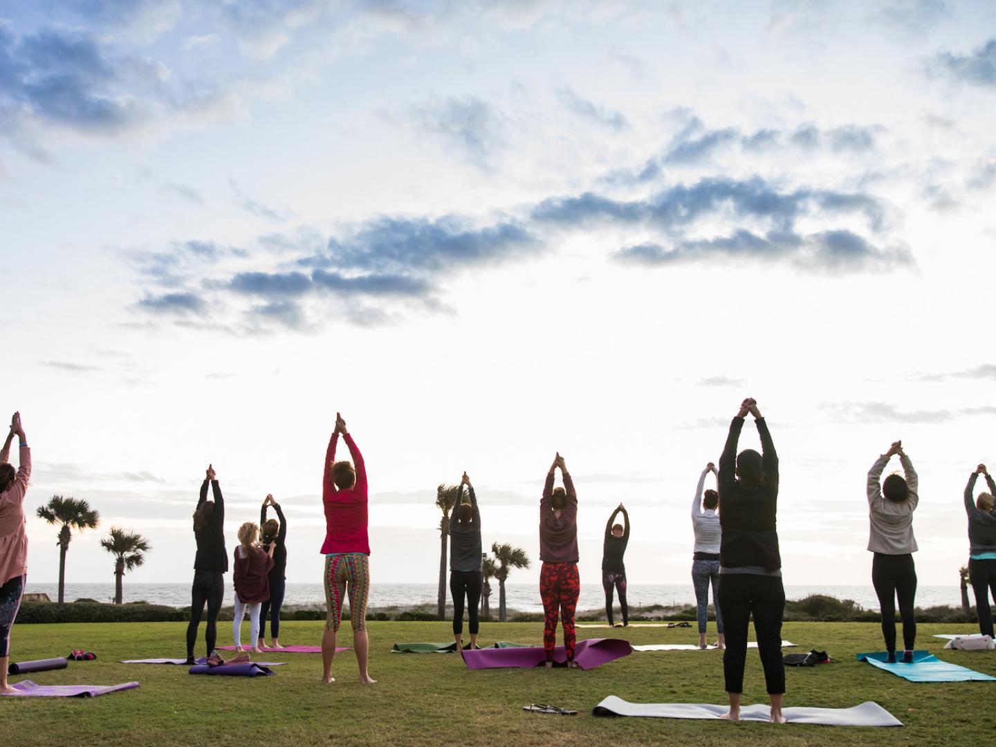 Beachfront yoga during the Amelia Island Wellness Festival