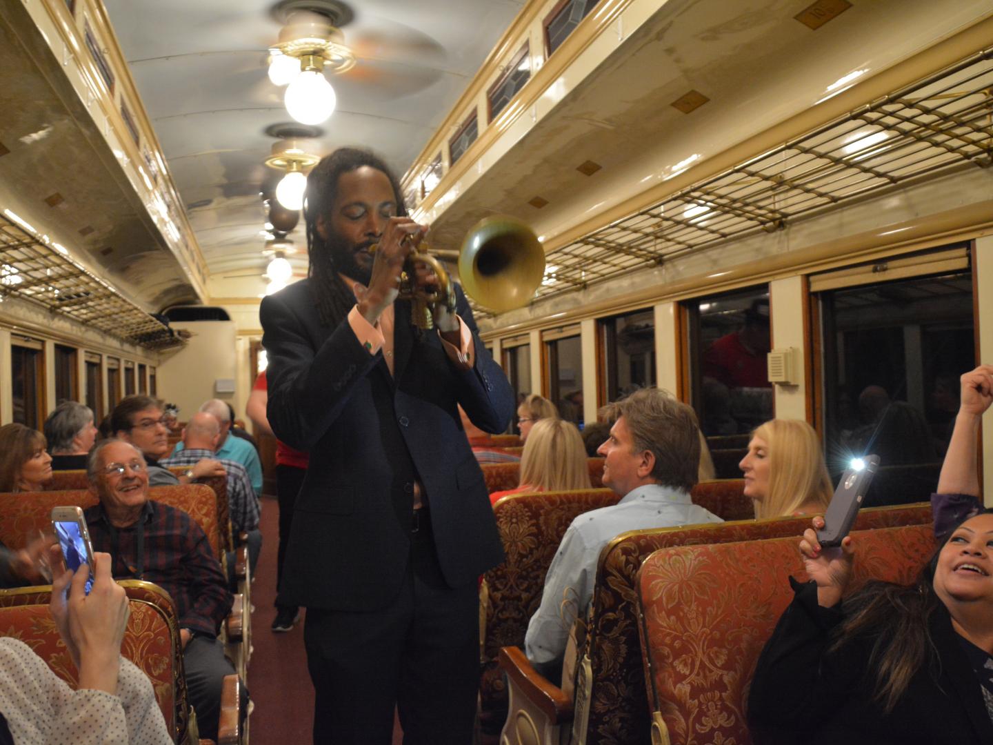 A performer playing live music during a Jazz Wine Train event in Grapevine, Texas