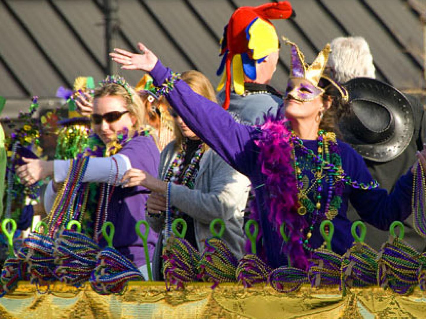 Throwing beads during Mardi Gras in Natchez, Mississippi