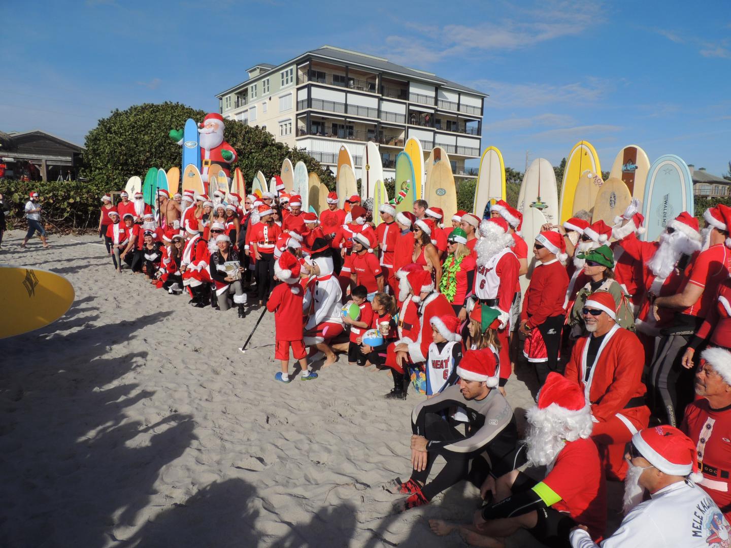 Surfers in Santa Claus costumes gathered on Cocoa Beach, Florida, during the annual Surfing Santas event