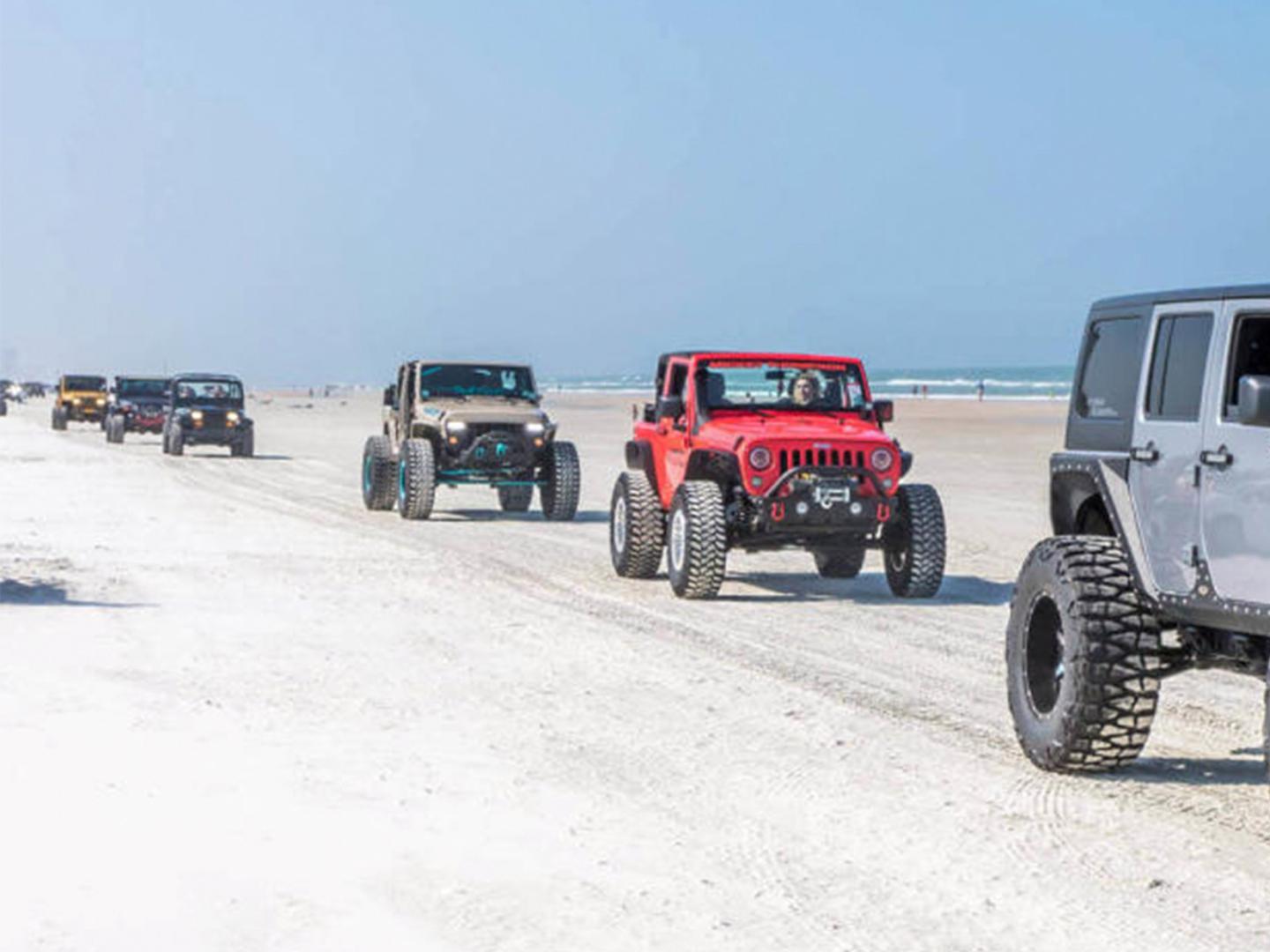 A caravan of jeeps during Jeep Beach in Daytona Beach, Florida