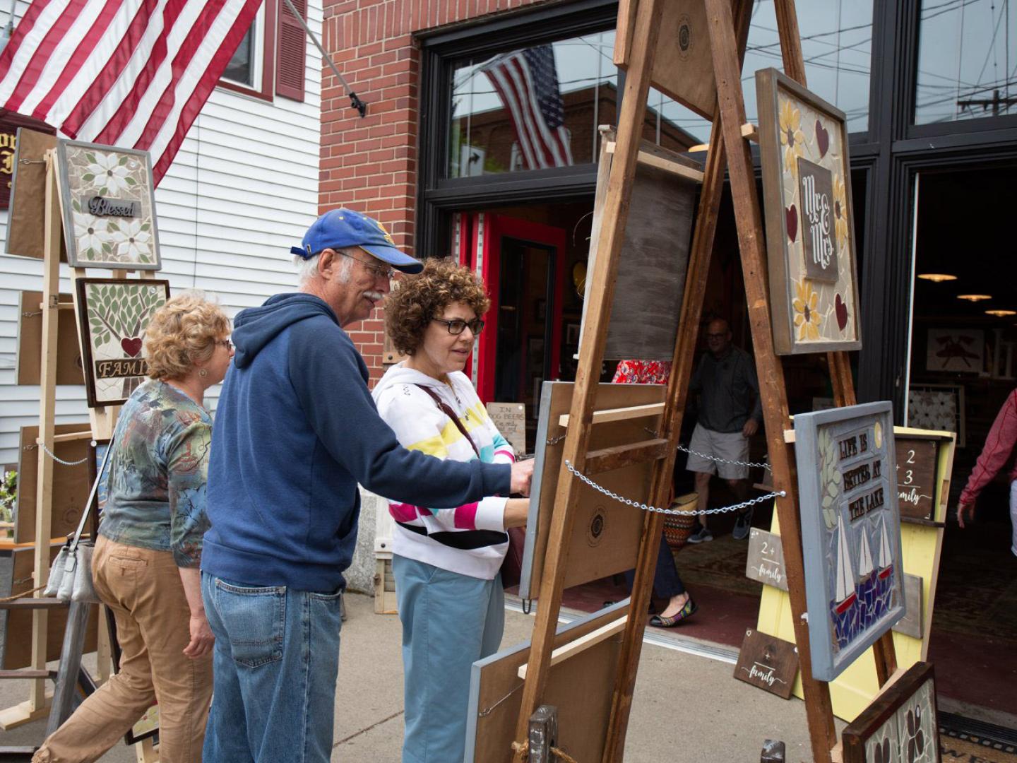 Admiring local art for sale at Fairport Canal Days in Rochester, New York