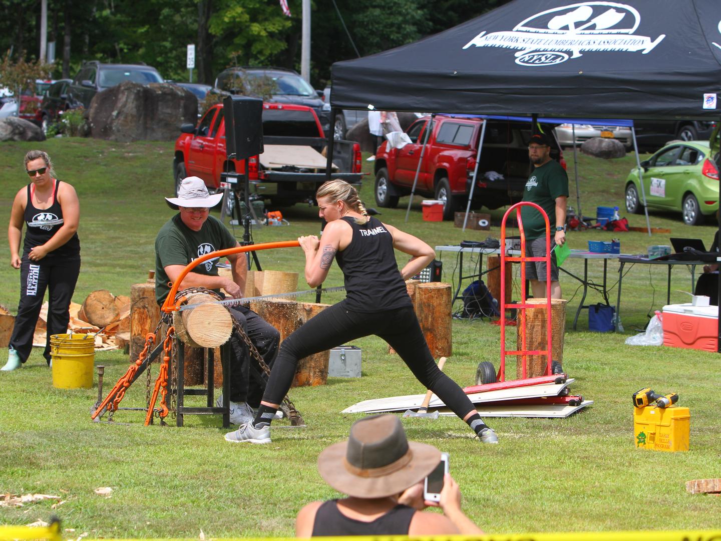 Athletes saw logs during Stony Creek Mountain Day Festival in Stony Creek, New York