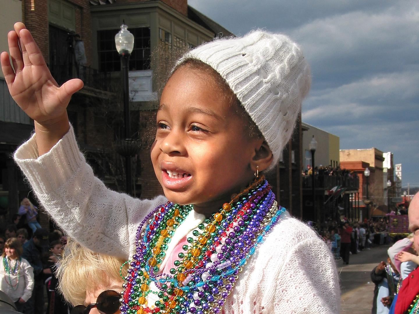 A child enjoying the annual Mardi Gras parade in Vicksburg, Mississippi
