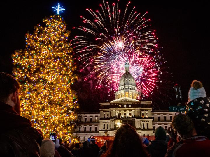 Christmas tree and Michigan Capitol with fireworks during Silver Bells in the City