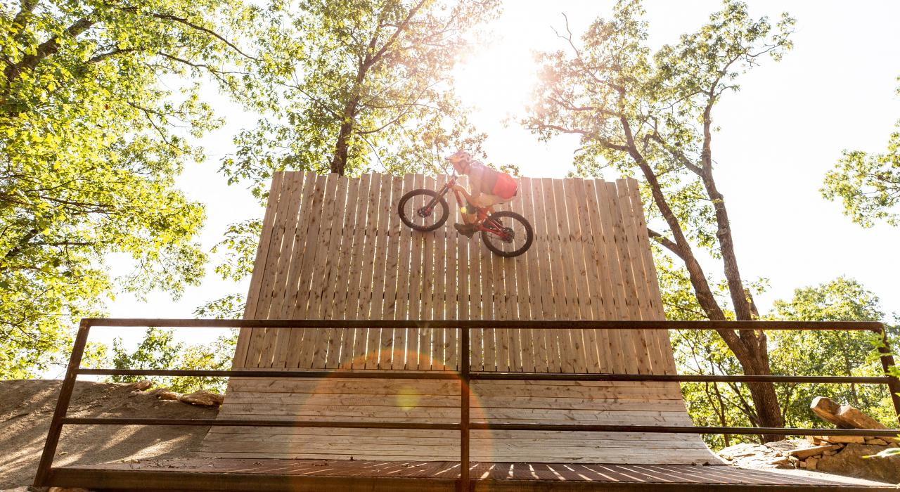 Mountain biker tackling an obstacle on the Slaughter Pen trails
