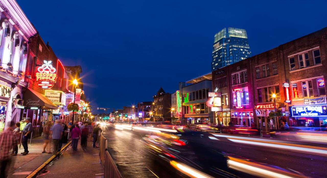 Enjoying the shops, bars and restaurants of busy downtown Nashville, Tennessee, as traffic zooms by on the street
