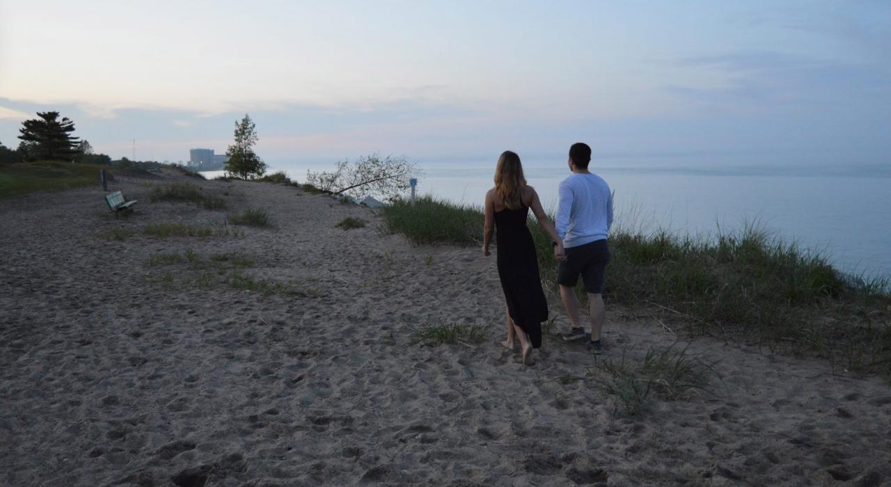 A couple strolls along Lake Michigan at Illinois Beach State Park