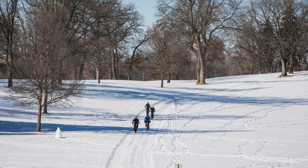 Riding fat tire bicycles in the snow at Brookview Golf & Lawn Bowling in Golden Valley