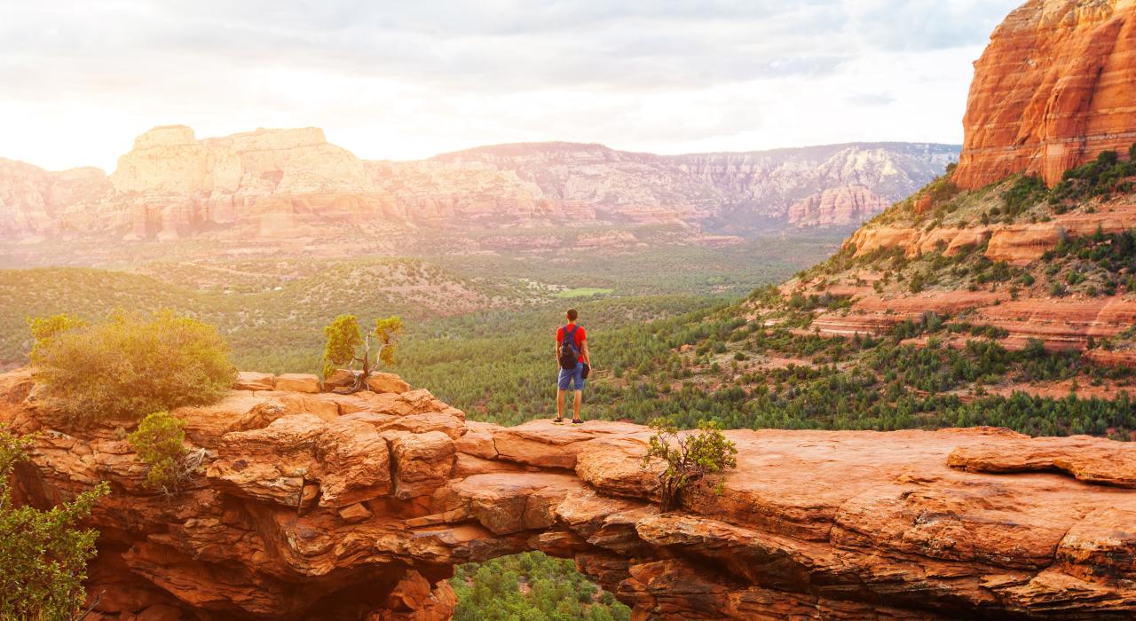 A hiker on Devils Bridge in Coconino National Forest near Sedona, Arizona